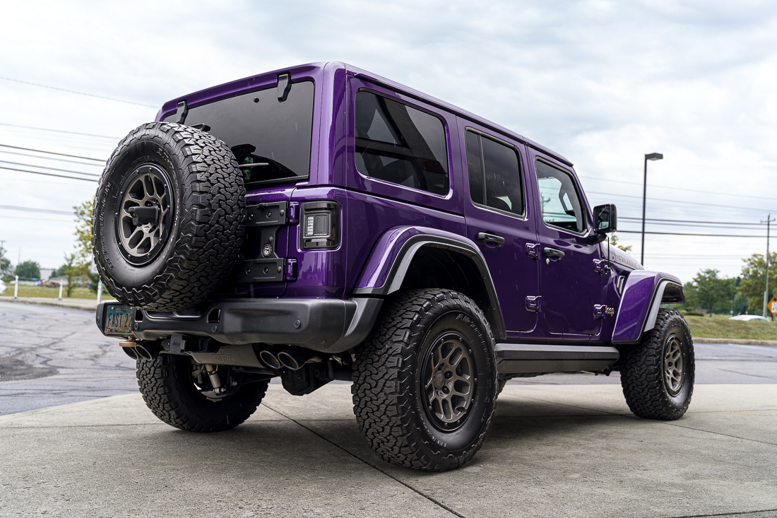 Purple Jeep 392 with black Oracle tail lights, amp running boards, LED side marker lights, Borla exhaust