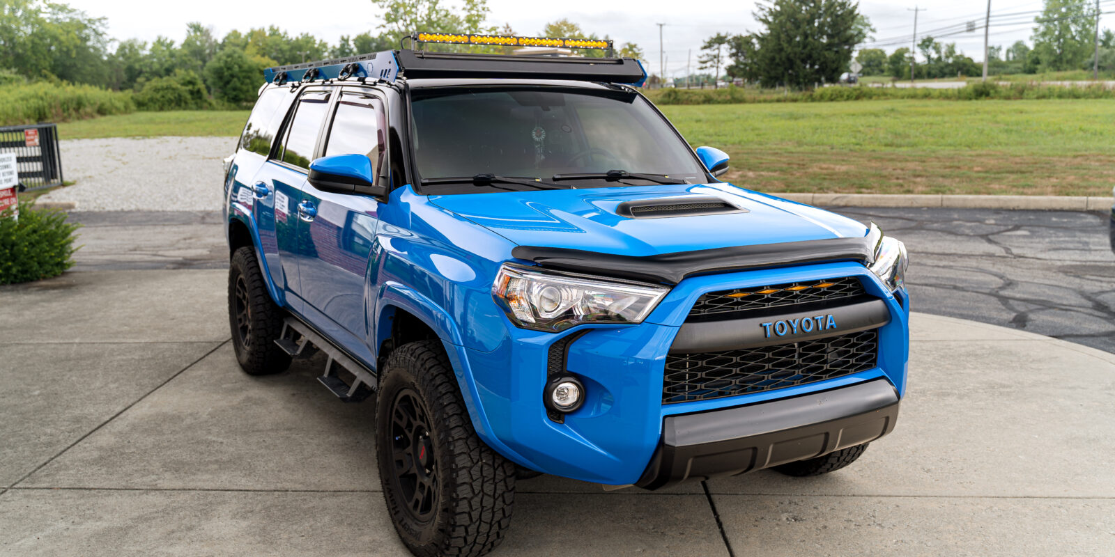 Blue Toyota 4Runner with upTOPOverland roof rack and Baja Designs light bar